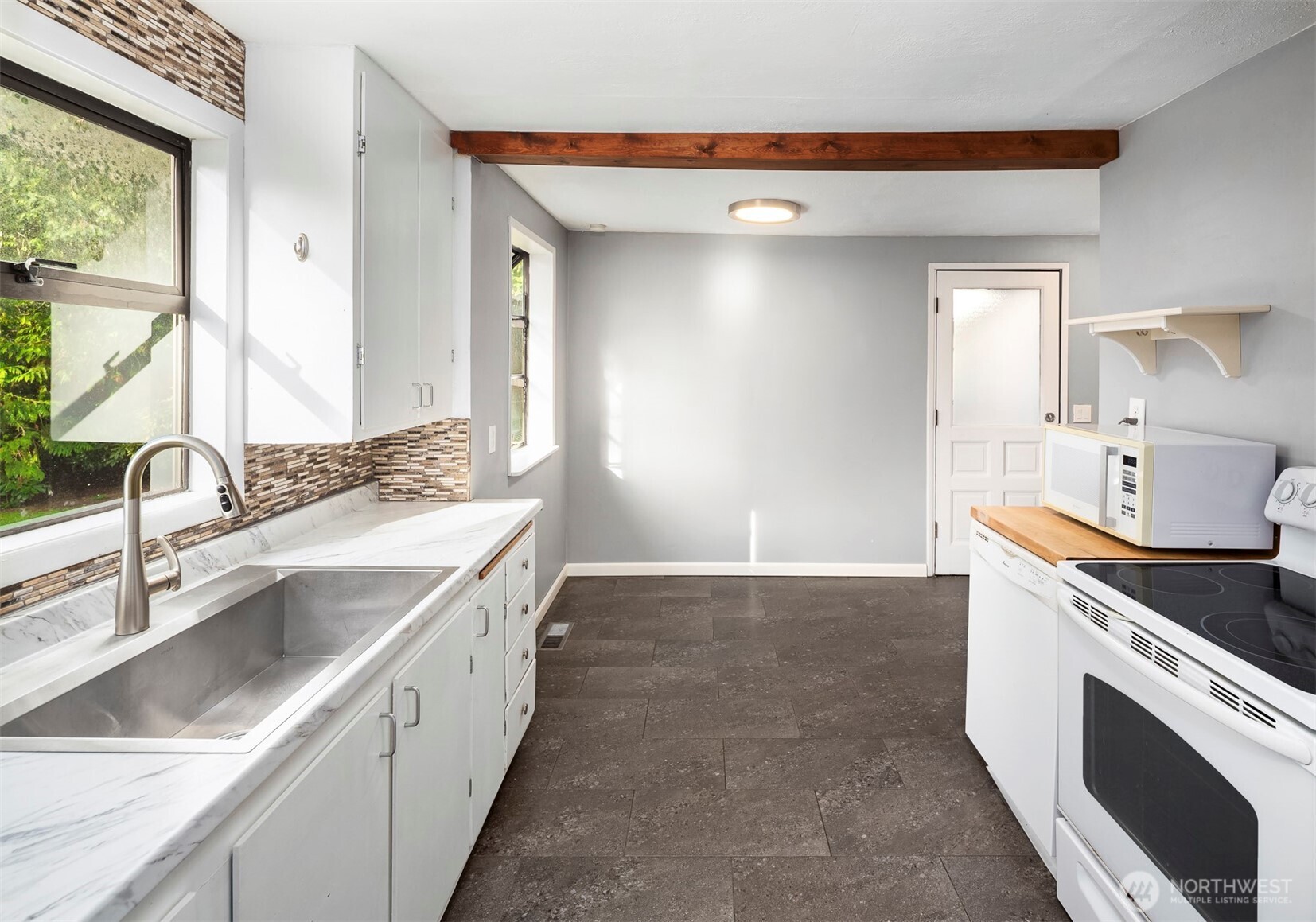 1504 Northeast 107th Street Seattle, WA 98125 - Photo 11 of 35 a kitchen with a sink stove and cabinets