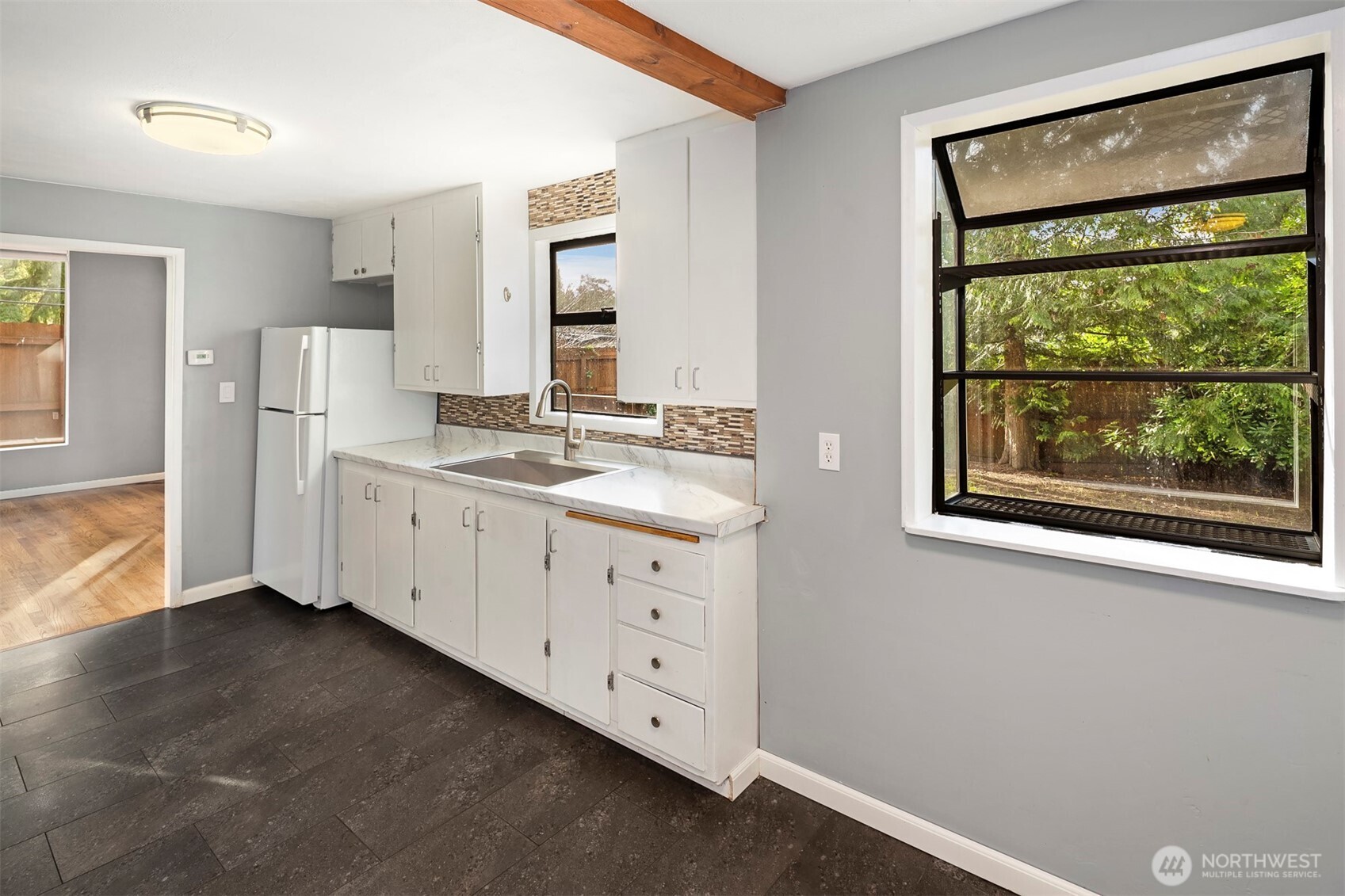 1504 Northeast 107th Street Seattle, WA 98125 - Photo 12 of 35 a spacious bathroom with a double vanity sink and a window