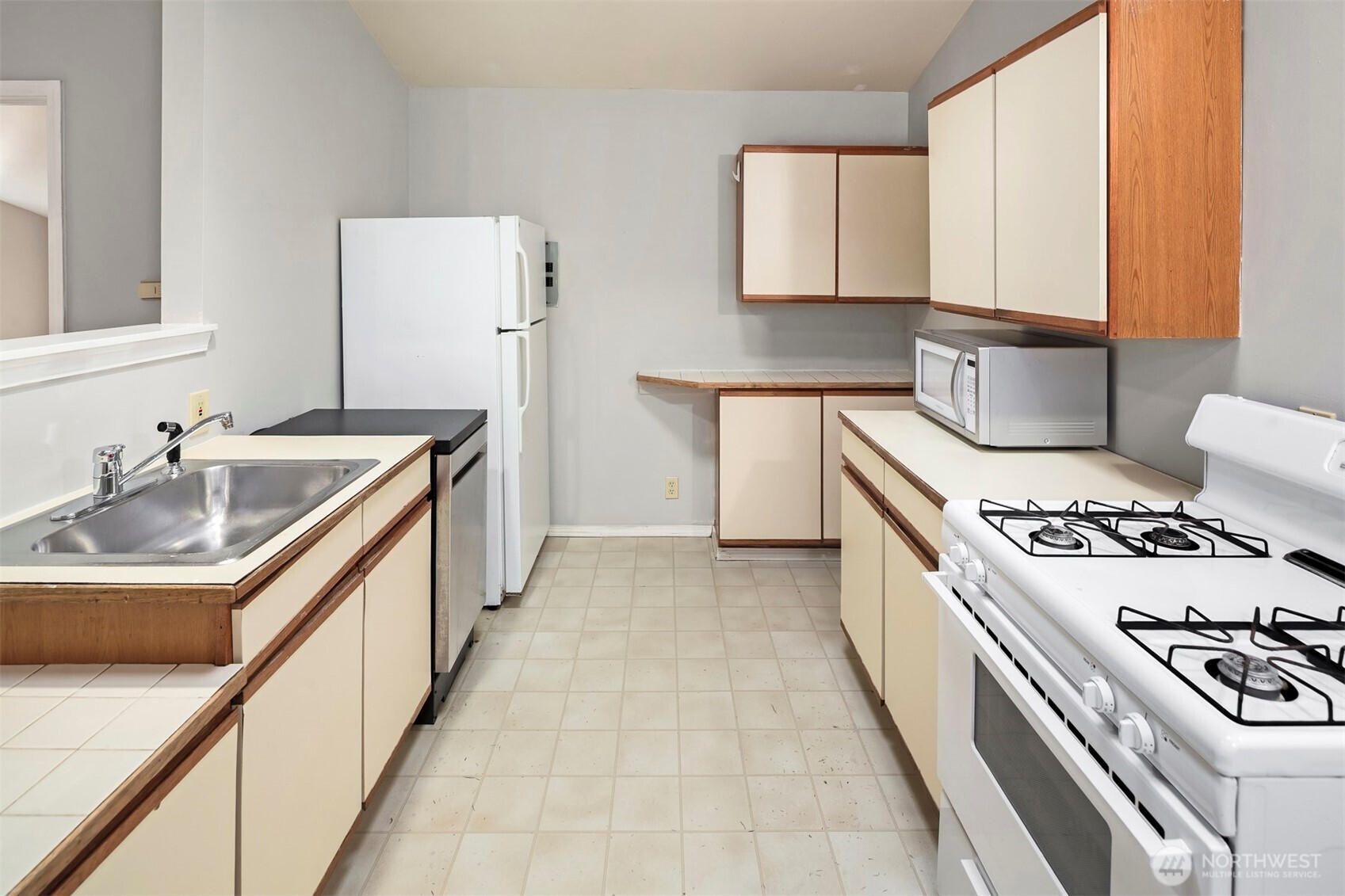 1504 Northeast 107th Street Seattle, WA 98125 - Photo 26 of 35 a kitchen with a stove sink and cabinets