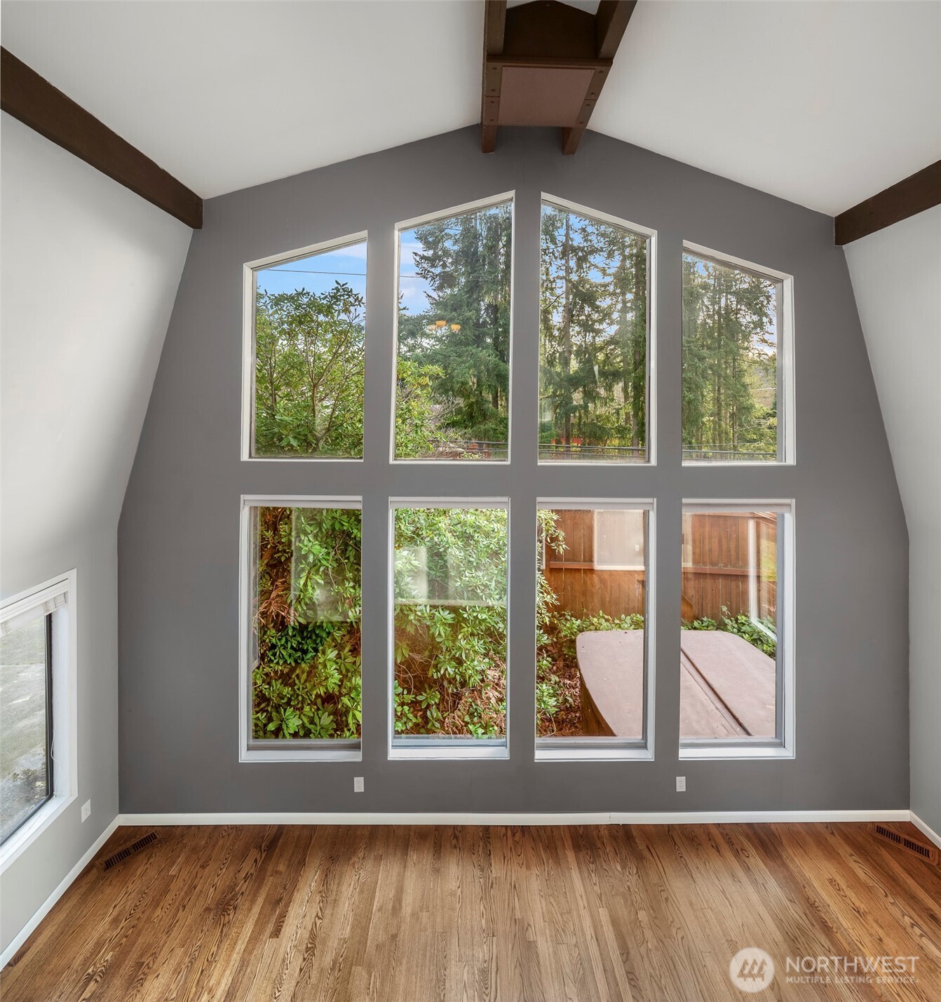 1504 Northeast 107th Street Seattle, WA 98125 - Photo 4 of 35 an empty room with wooden floor and windows