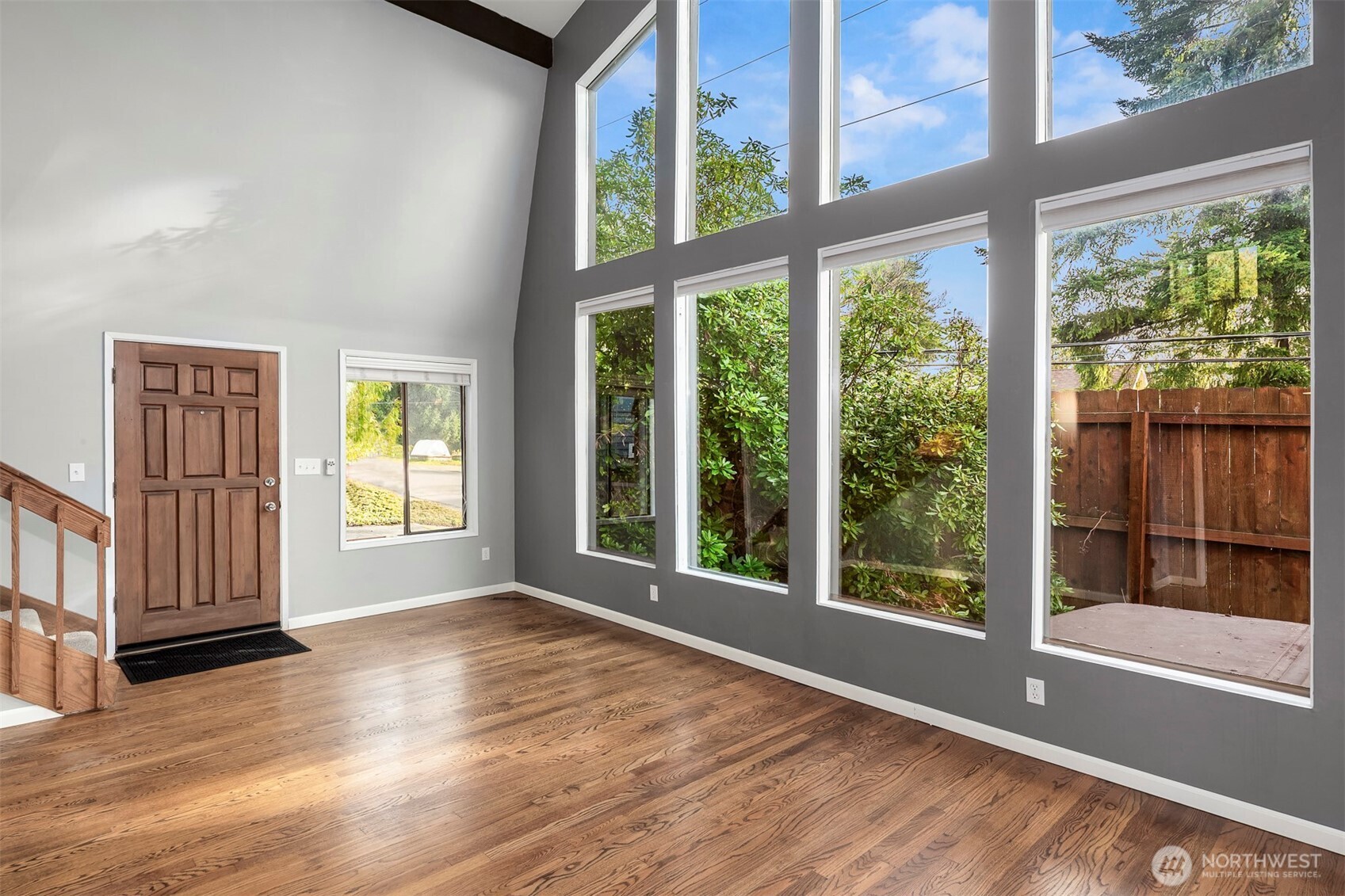 1504 Northeast 107th Street Seattle, WA 98125 - Photo 5 of 35 a view of an empty room with wooden floor and a window