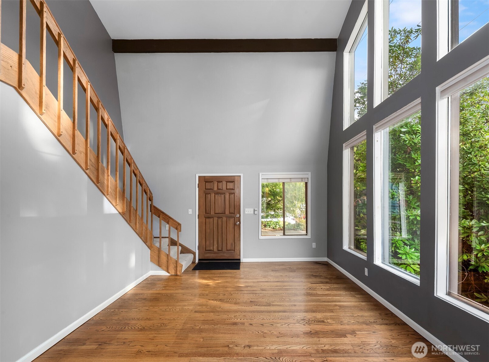 1504 Northeast 107th Street Seattle, WA 98125 - Photo 8 of 35 a view of an entryway with wooden floor and windows
