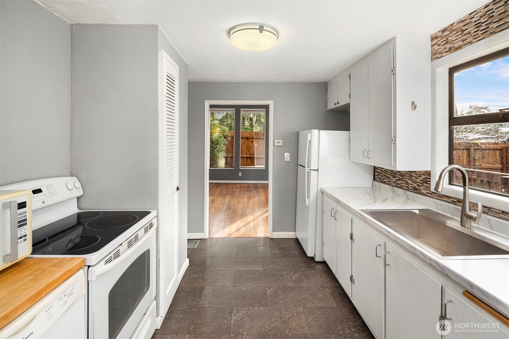 1504 Northeast 107th Street Seattle, WA 98125 - Photo 10 of 35 a kitchen with granite countertop a sink stove and refrigerator
