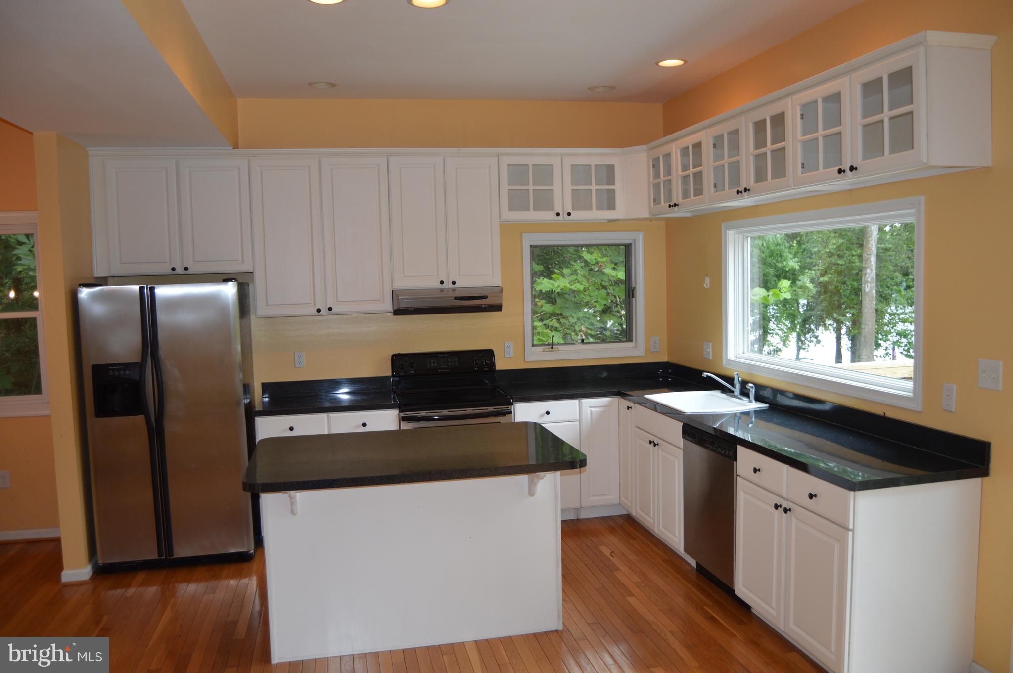 1529 Knott Road Shepherdstown, WV 25443 - Photo 6 of 20 a kitchen with stainless steel appliances granite countertop a stove a sink and a refrigerator