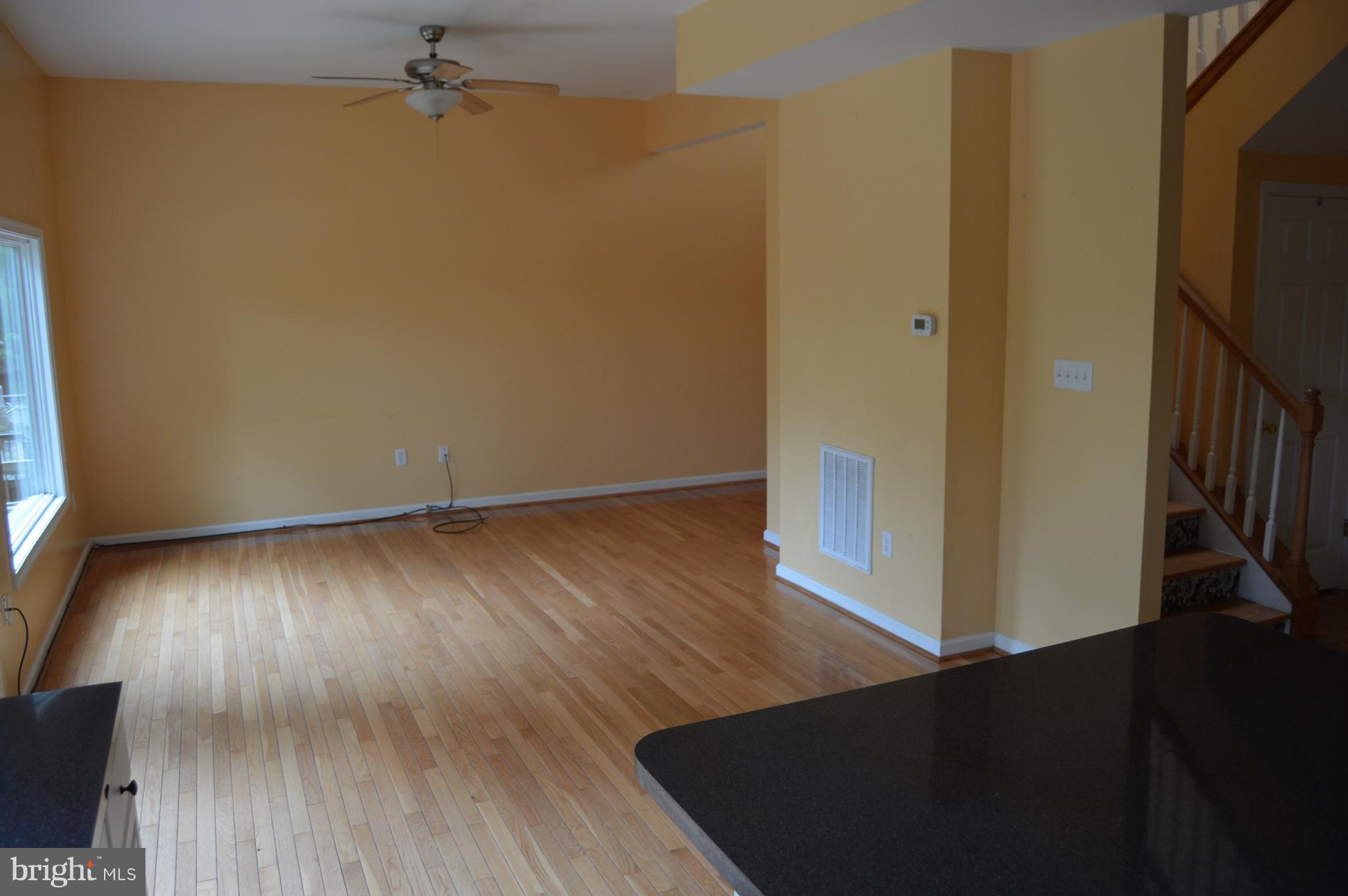1529 Knott Road Shepherdstown, WV 25443 - Photo 9 of 20 an empty room with wooden floor and a hallway