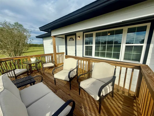 a view of a chairs and a table in the balcony