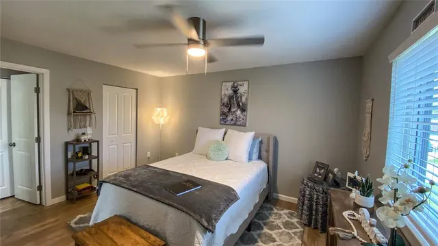 a bedroom with a bed and a chandelier