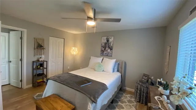 a bedroom with a bed and a window