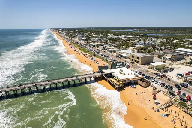 an aerial view of a house with a swimming pool a yard and outdoor seating