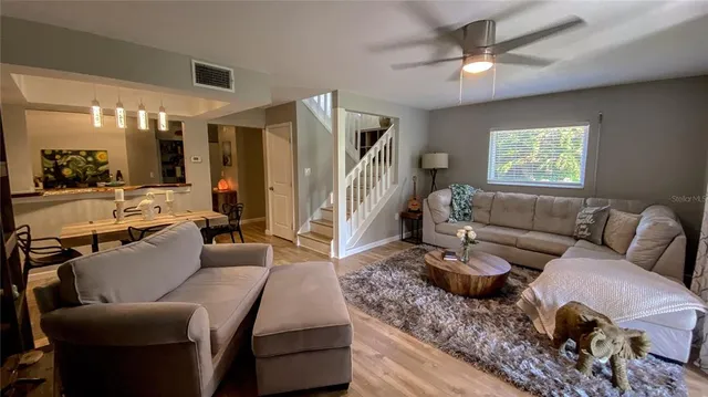 a living room with furniture and a chandelier