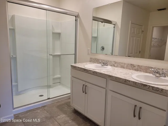 a bathroom with a glass shower door