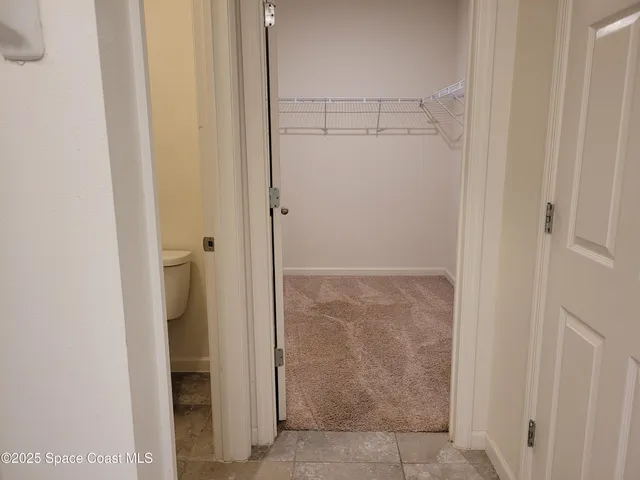 a bathroom with a granite countertop bathtub shower sink vanity and toilet