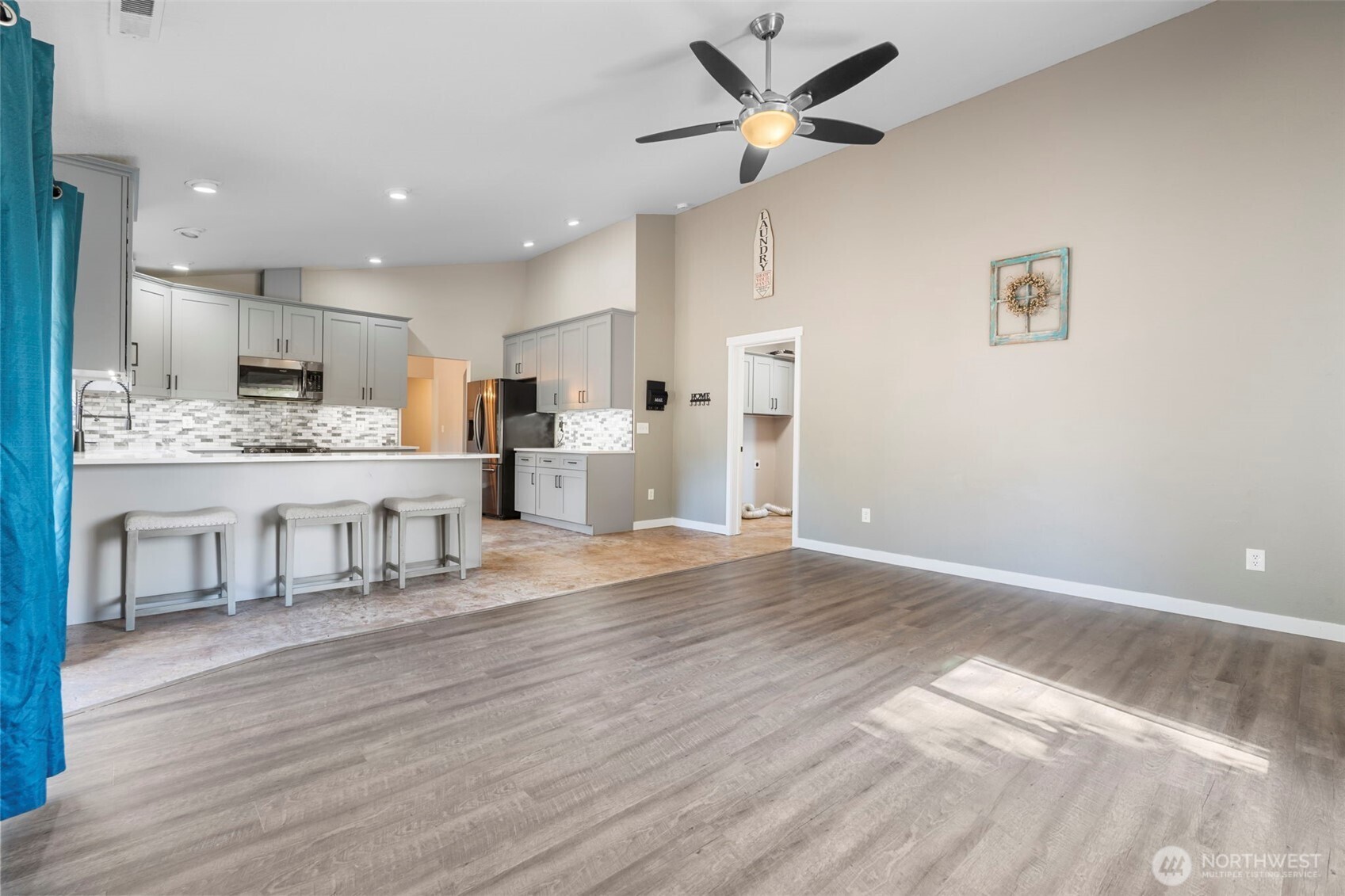 9523 184th Avenue Southwest Rochester, WA 98579 - Photo 16 of 40 a living room with stainless steel appliances kitchen island hardwood floor and a kitchen view