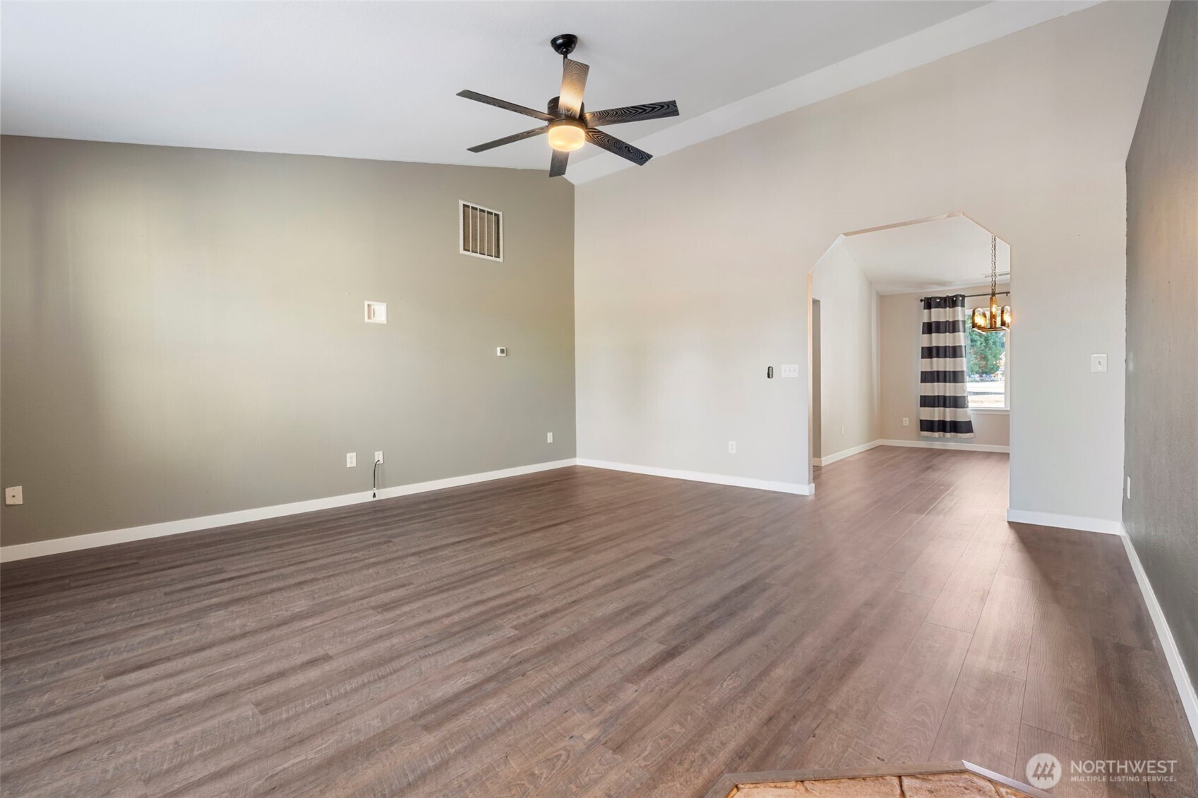 9523 184th Avenue Southwest Rochester, WA 98579 - Photo 7 of 40 an empty room with wooden floor chandelier fan and windows