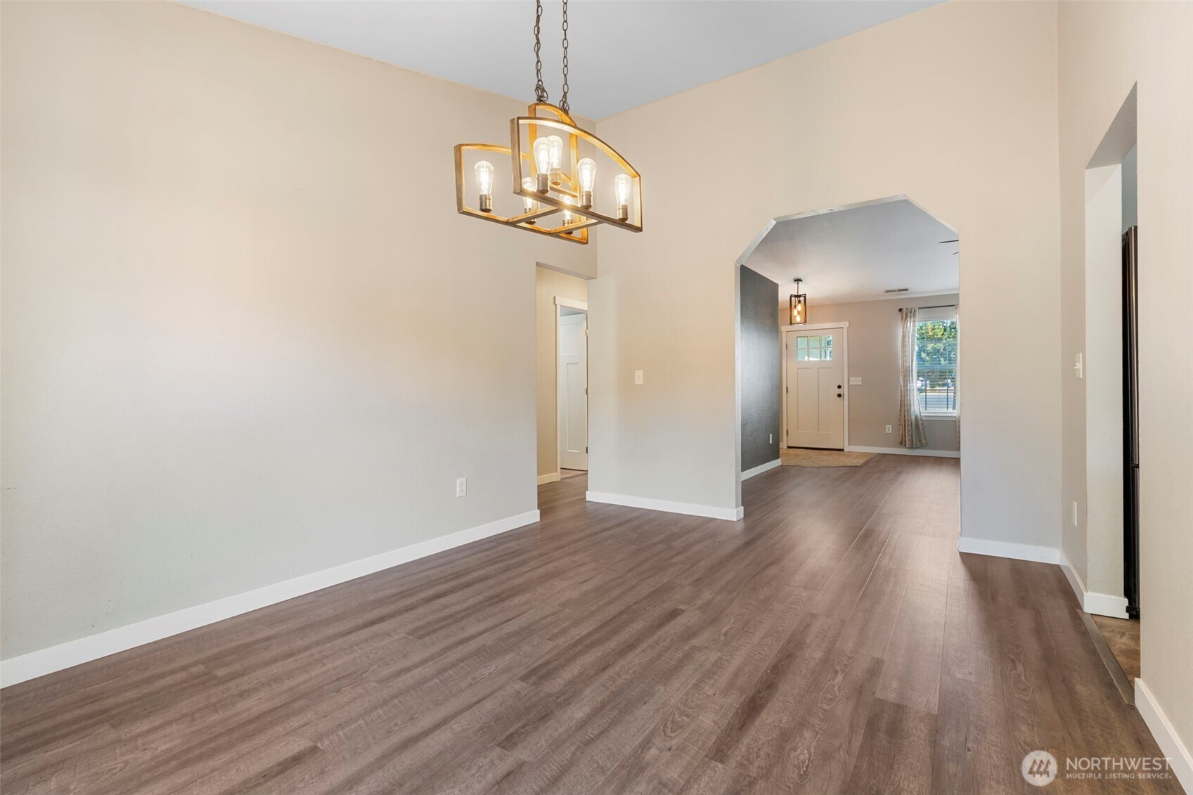 9523 184th Avenue Southwest Rochester, WA 98579 - Photo 10 of 40 a view of a hallway with wooden floor and chandelier