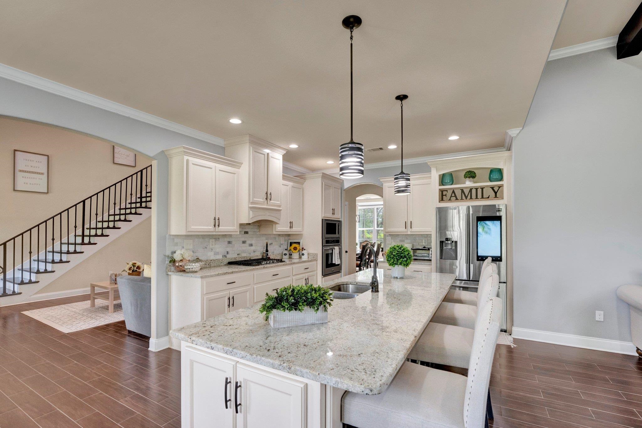 3270 Rast Road Millington, TN 38053 - Photo 10 of 40 Kitchen featuring wood tiled floors, arched walkways, a breakfast bar area, stainless steel appliances, and open shelves