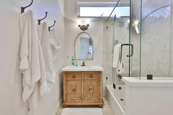 a bathroom with a sink a toilet and a mirror