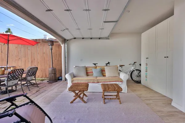 a living room with patio furniture and a flat screen tv
