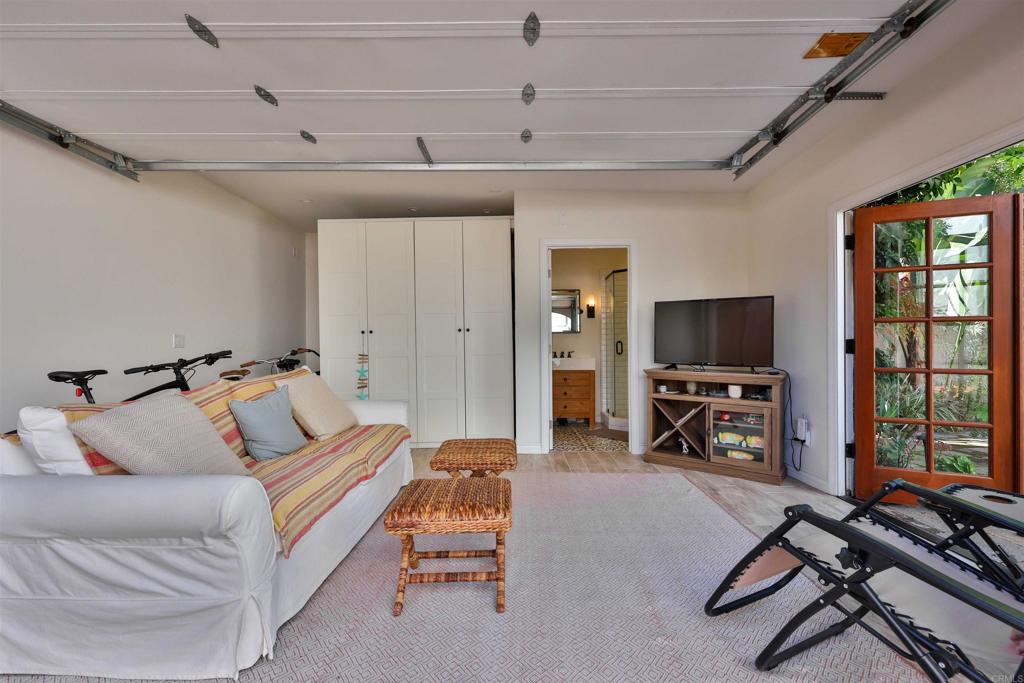 408 5th Street Coronado, CA 92118 - Photo 41 of 56 a living room with furniture a flat screen tv and a large window