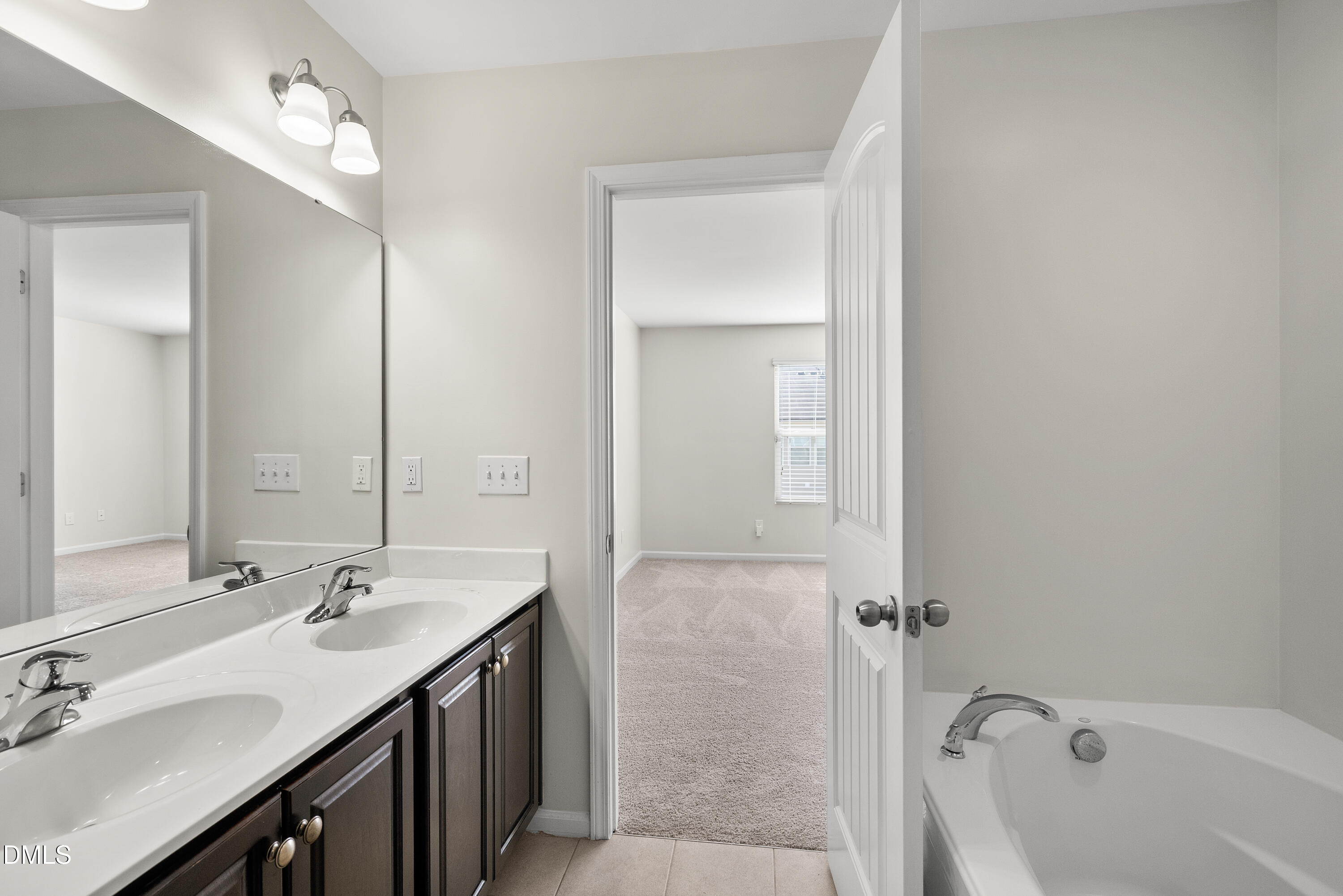 309 Leighann Ridge Lane Rolesville, NC 27571 - Photo 15 of 25 a bathroom with a tub a sink and mirror