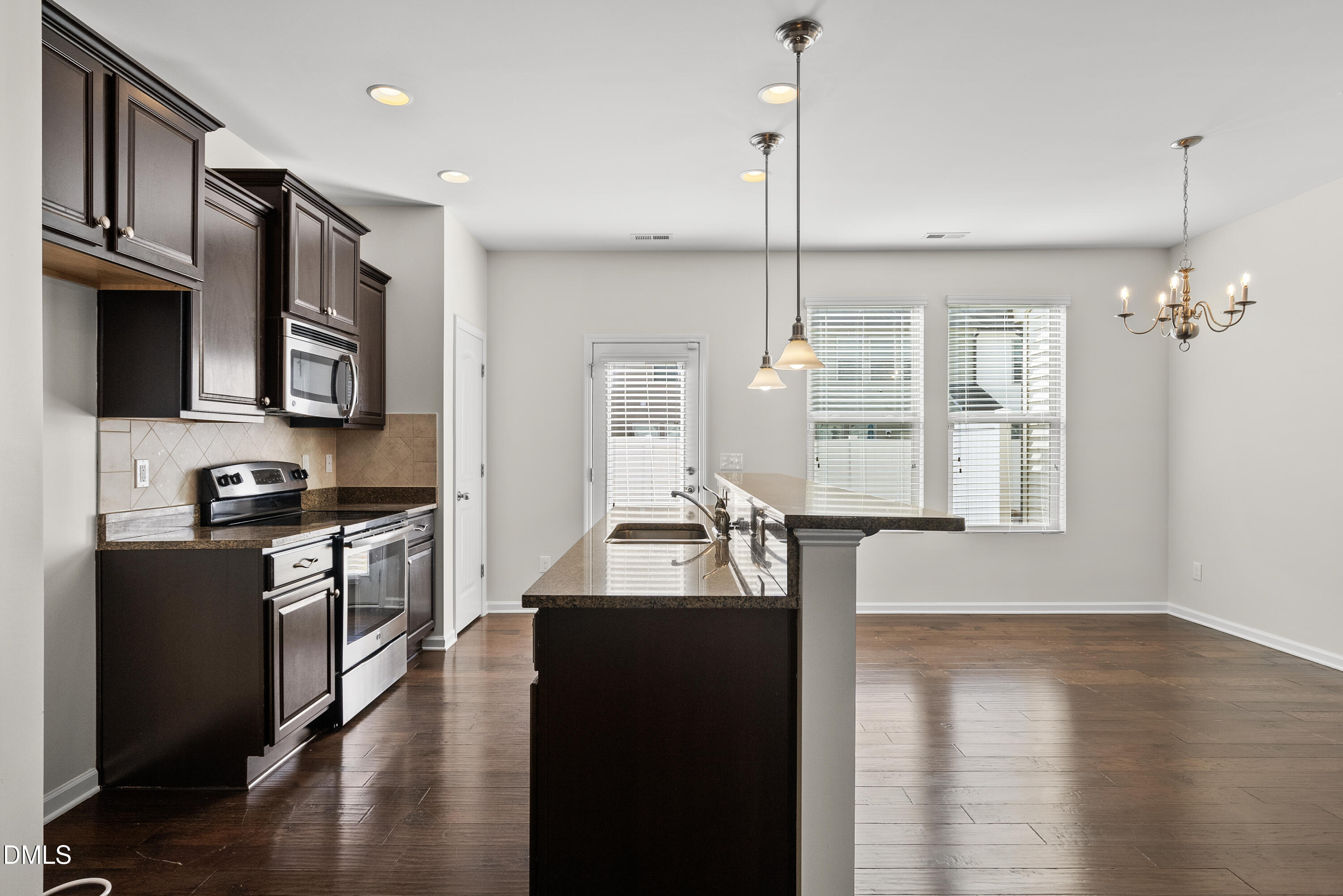 309 Leighann Ridge Lane Rolesville, NC 27571 - Photo 3 of 25 a kitchen with microwave a stove and refrigerator