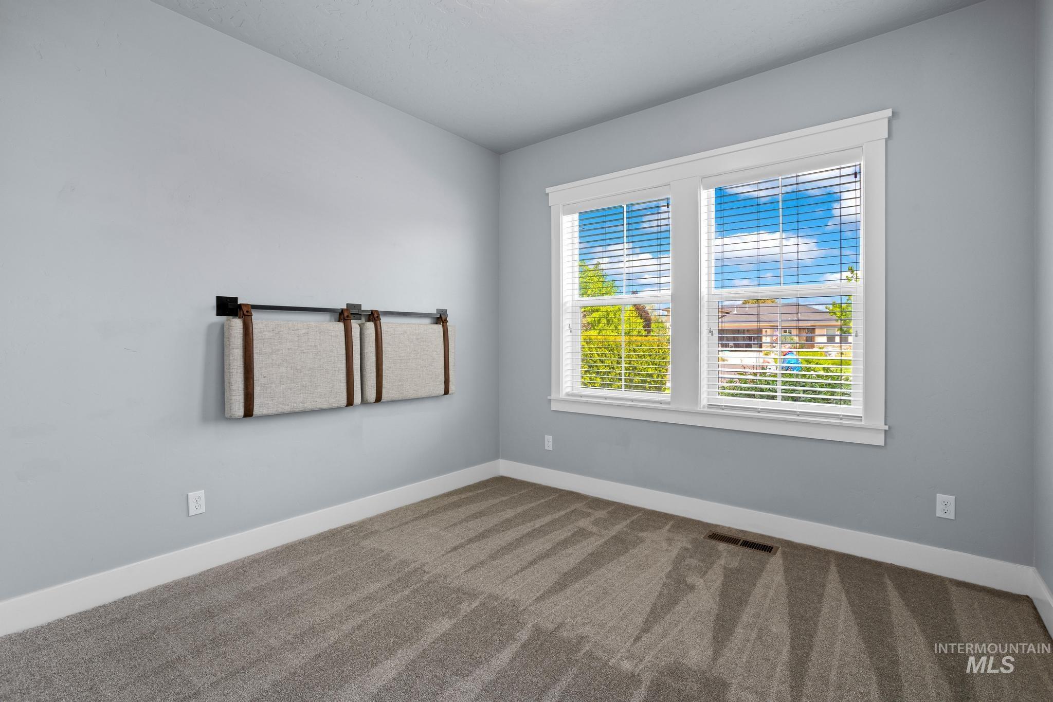 2681 East Rhyolite Court Nampa, ID 83686 - Photo 33 of 48 Bright room featuring light gray walls, a textured gray carpet, and white baseboards