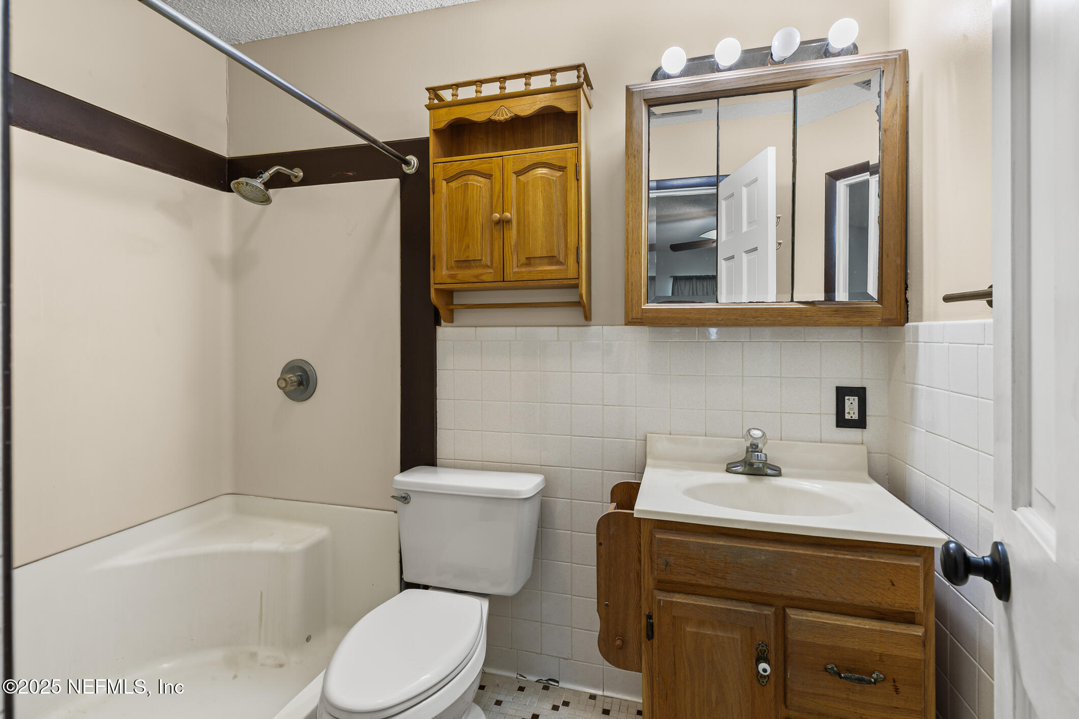 1388 Highland Boulevard St. Augustine, FL 32084 - Photo 14 of 54 a bathroom with a sink a toilet and shower
