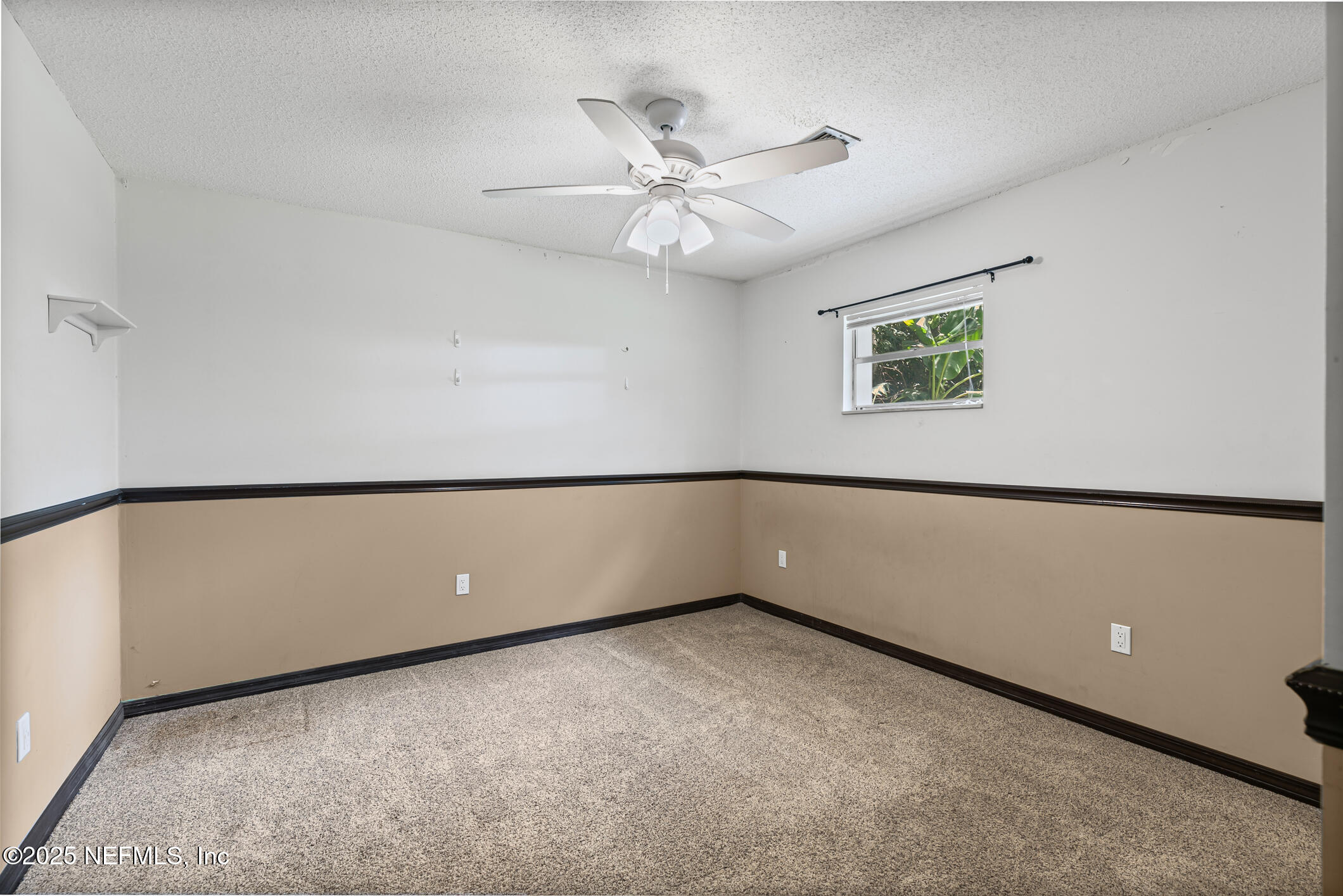 1388 Highland Boulevard St. Augustine, FL 32084 - Photo 16 of 54 an empty room with a ceiling fan and a window
