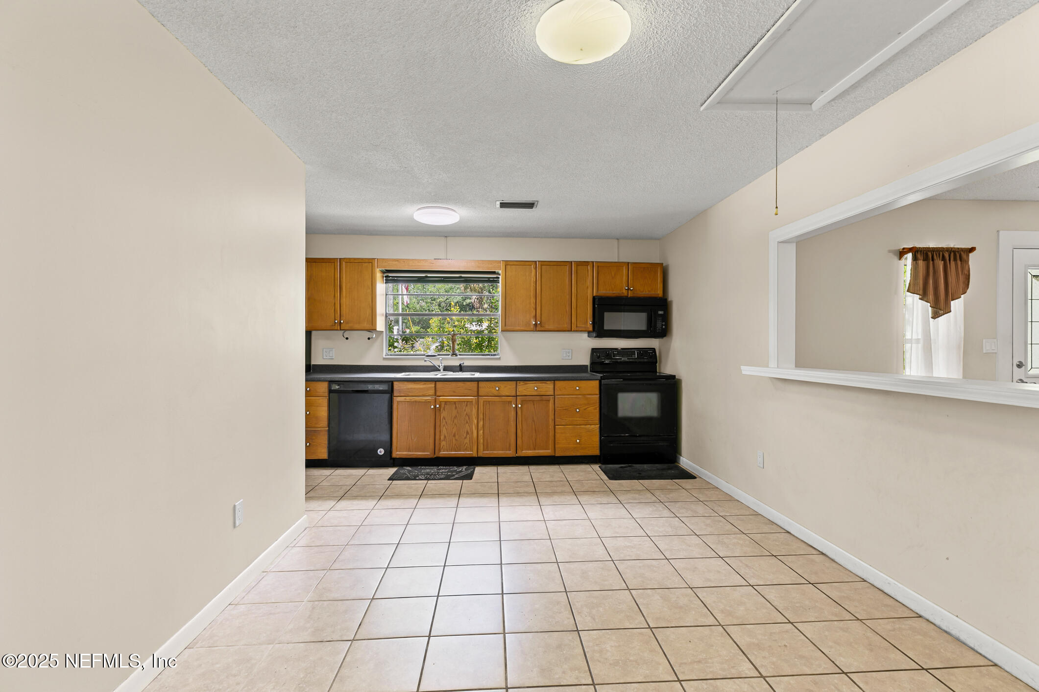 1388 Highland Boulevard St. Augustine, FL 32084 - Photo 26 of 54 a kitchen with stainless steel appliances a sink and cabinets