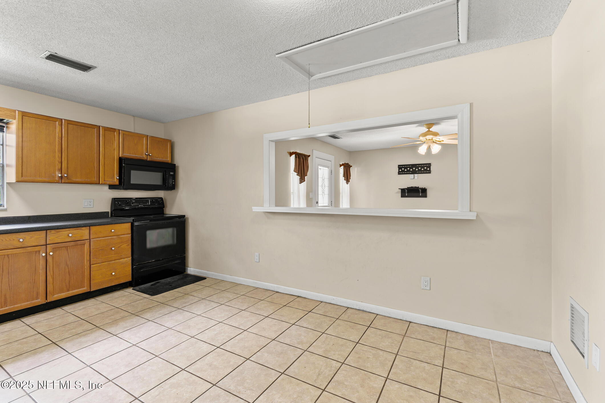 1388 Highland Boulevard St. Augustine, FL 32084 - Photo 27 of 54 a kitchen with granite countertop white cabinets and stainless steel appliances