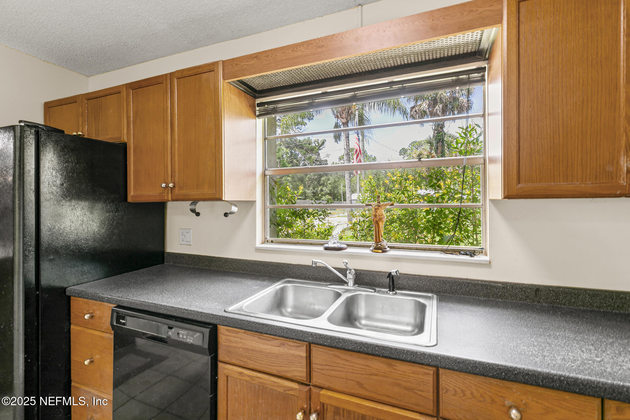 1388 Highland Boulevard St. Augustine, FL 32084 - Photo 32 of 54 a kitchen with a sink and a window