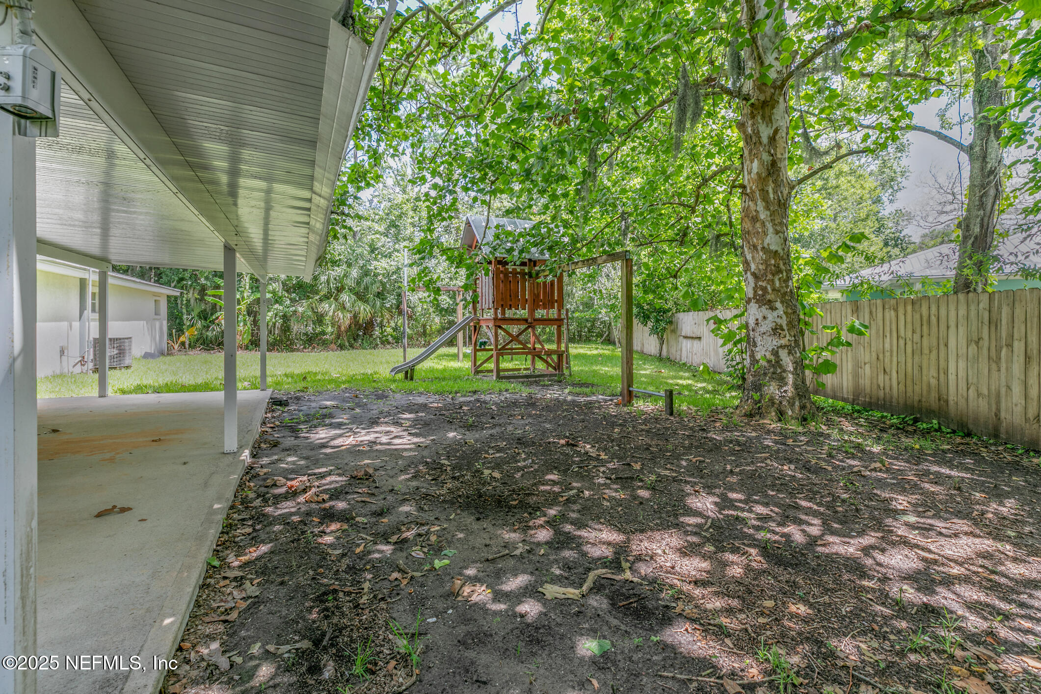 1388 Highland Boulevard St. Augustine, FL 32084 - Photo 50 of 54 a view of a backyard with large trees