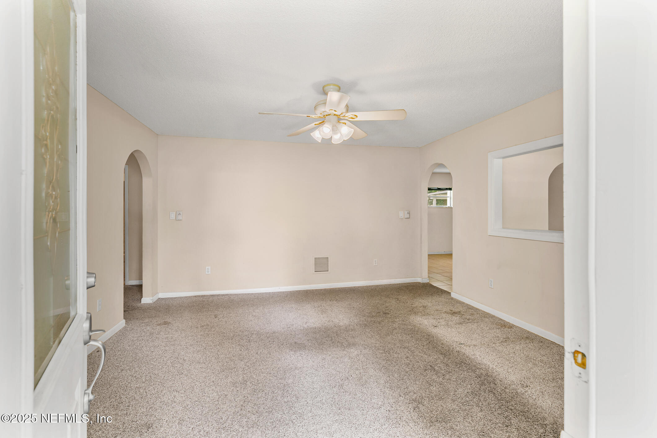 1388 Highland Boulevard St. Augustine, FL 32084 - Photo 7 of 54 an empty room with chandelier fan and closet area