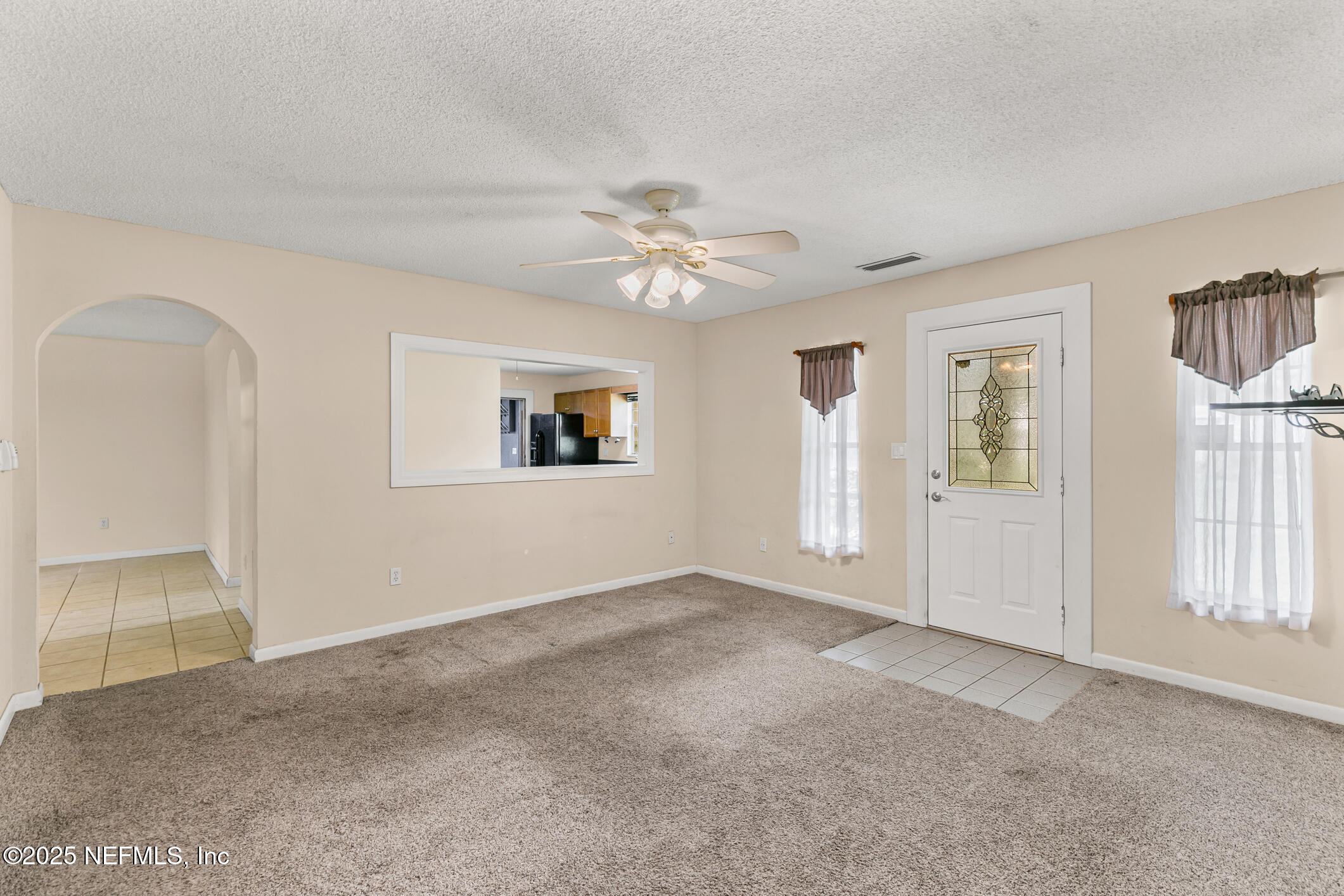 1388 Highland Boulevard St. Augustine, FL 32084 - Photo 9 of 54 an empty room with windows and ceiling fan