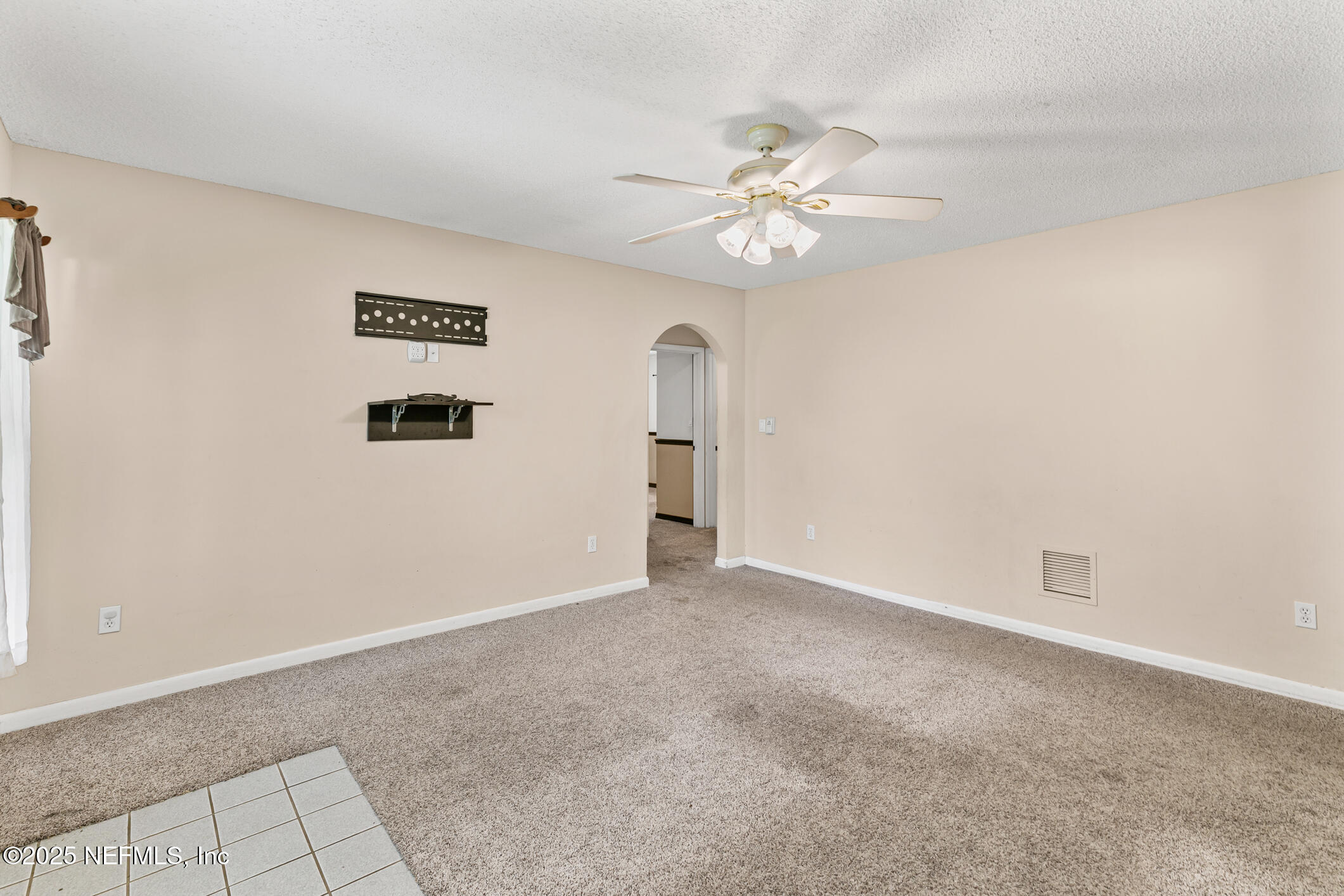1388 Highland Boulevard St. Augustine, FL 32084 - Photo 10 of 54 an empty room with windows and fan
