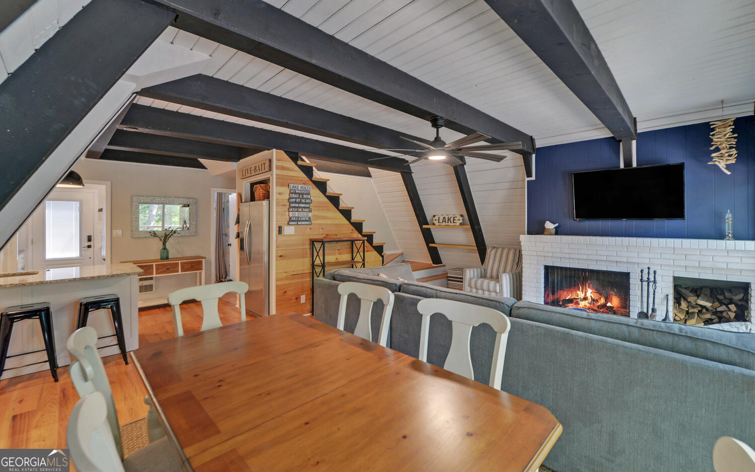 1047 Tranquility Lane Hartwell, GA 30643 - Photo 12 of 60 a living room with furniture a flat screen tv and a fireplace