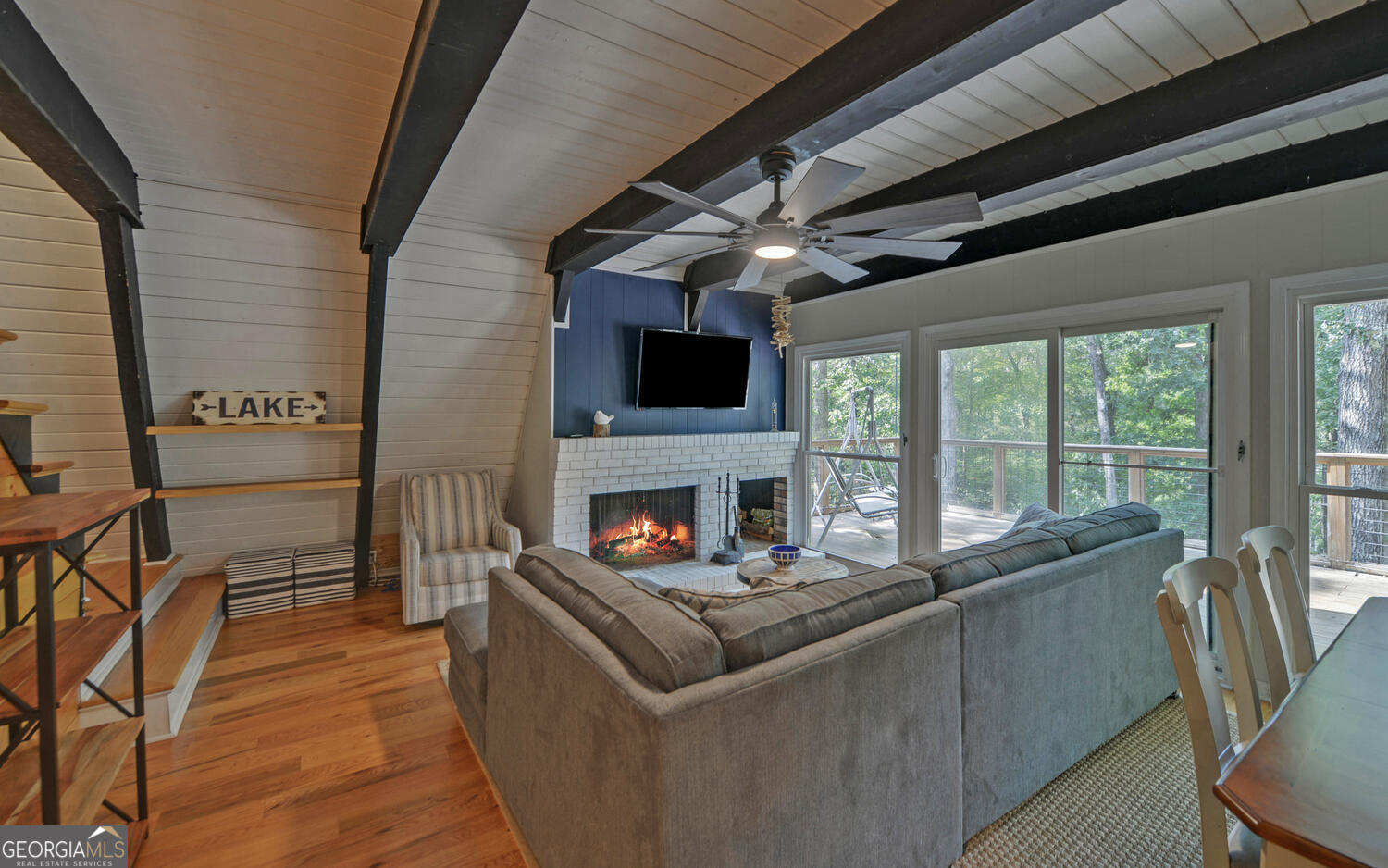 1047 Tranquility Lane Hartwell, GA 30643 - Photo 13 of 60 a living room with furniture a fireplace and a flat screen tv
