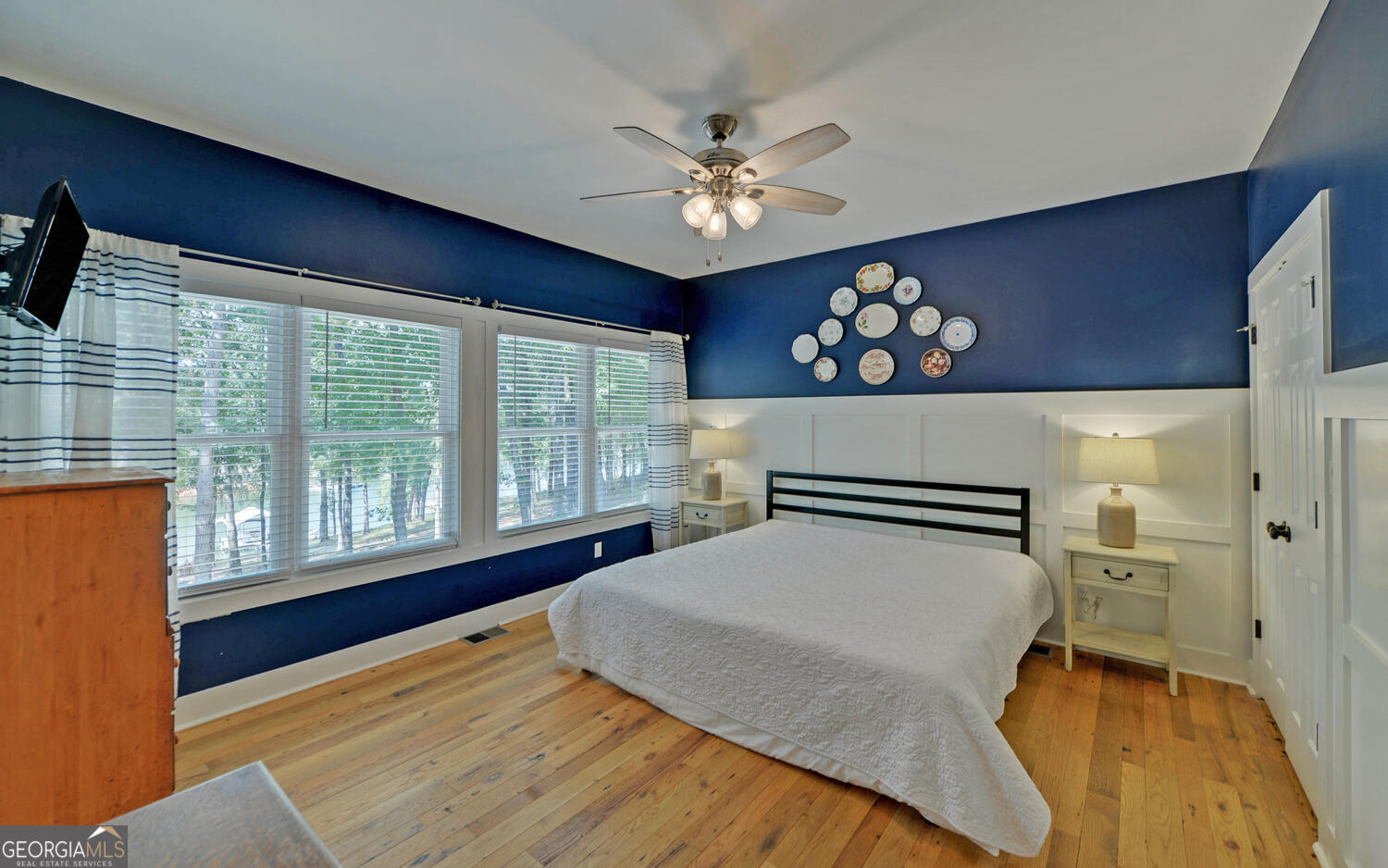 1047 Tranquility Lane Hartwell, GA 30643 - Photo 15 of 60 a bedroom with a large bed and a chandelier