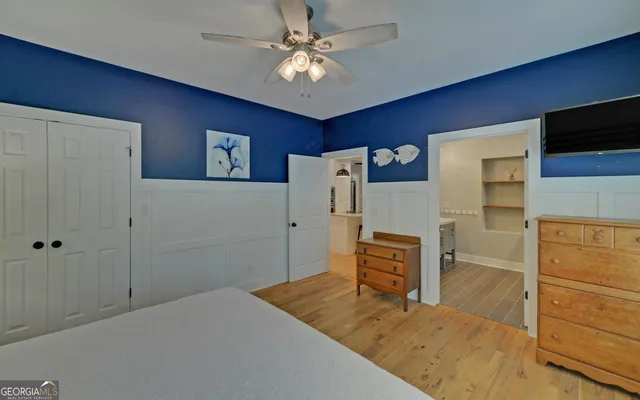 a bedroom with a bed and a ceiling fan