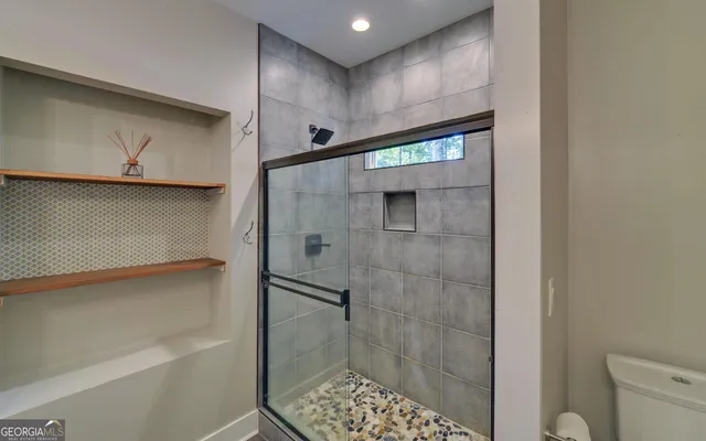 a bathroom with a sink toilet and shower