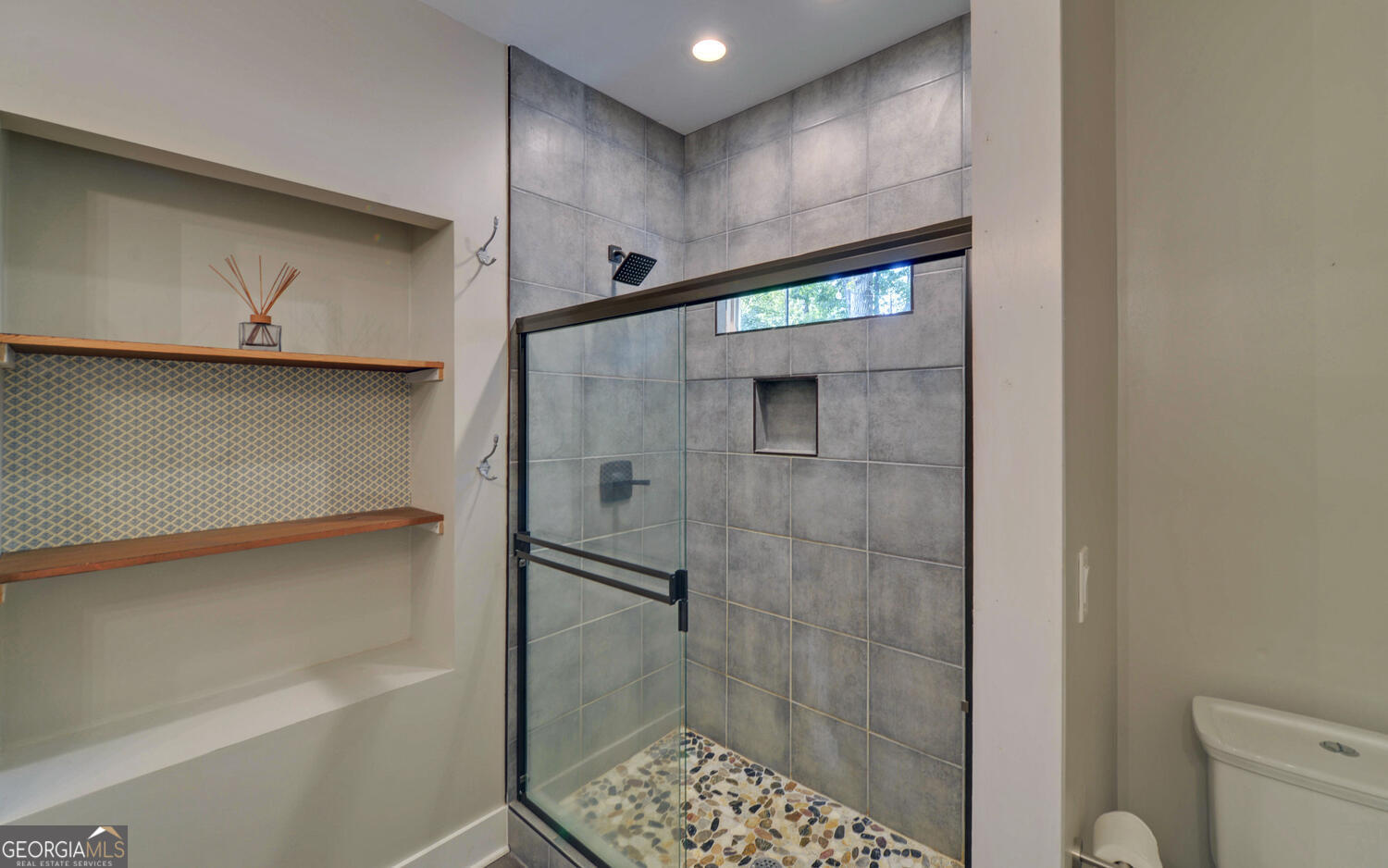 1047 Tranquility Lane Hartwell, GA 30643 - Photo 19 of 60 a bathroom with a shower and a toilet