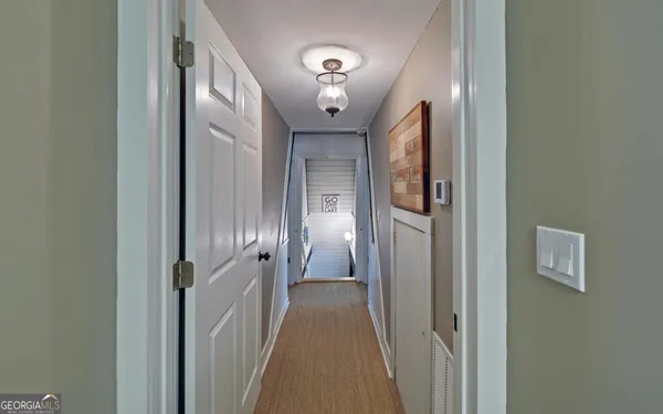 a spacious bedroom with a bed and a chandelier
