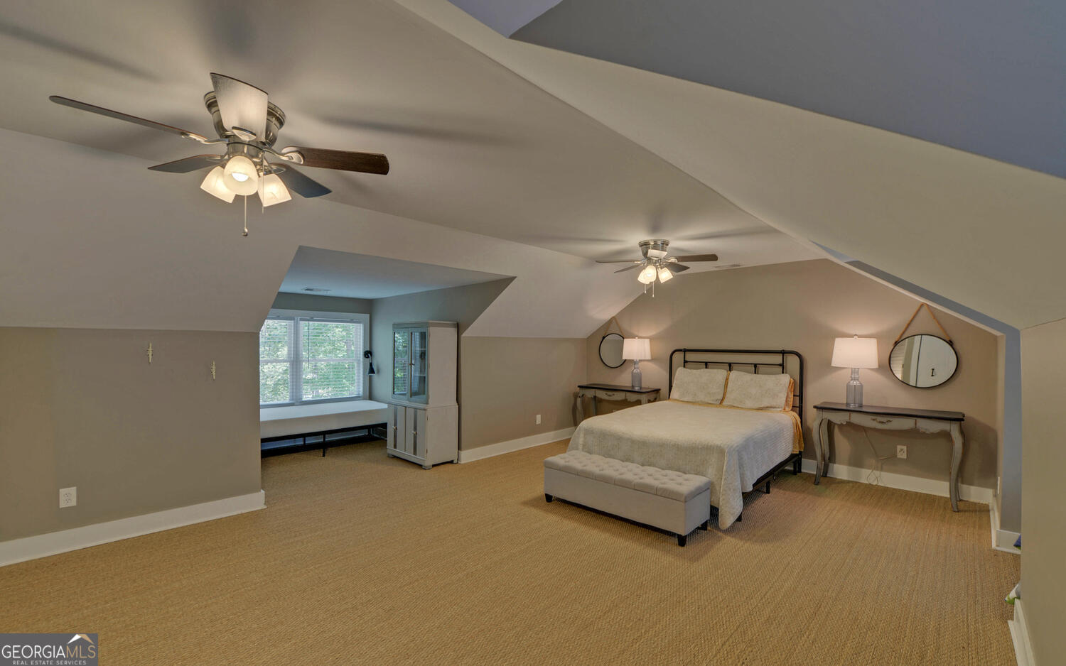 1047 Tranquility Lane Hartwell, GA 30643 - Photo 34 of 60 a spacious bedroom with a bed and a chandelier