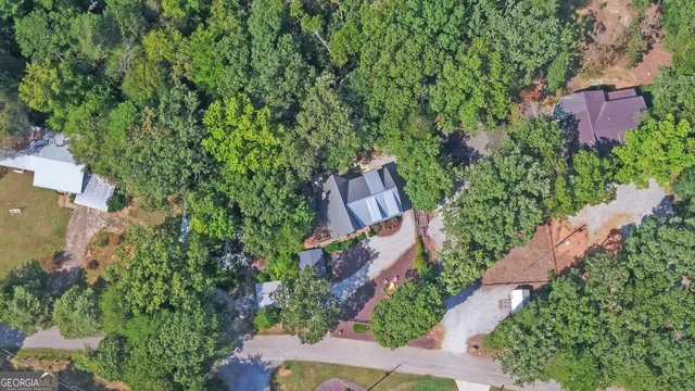 an aerial view of house with yard and outdoor seating
