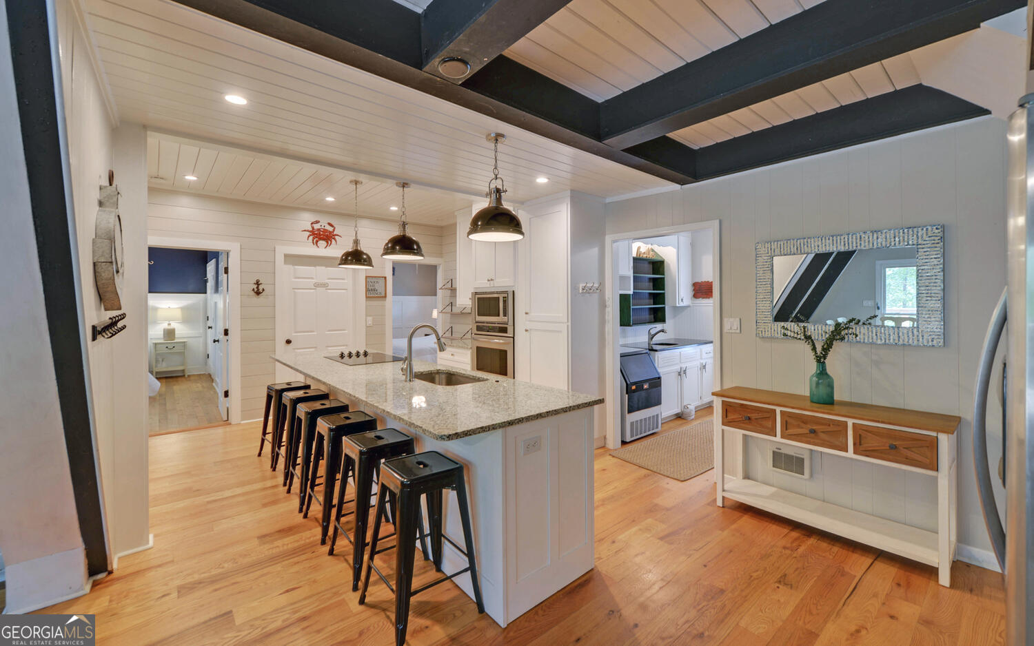 1047 Tranquility Lane Hartwell, GA 30643 - Photo 6 of 60 a kitchen with stainless steel appliances kitchen island granite countertop wooden floors and view of living room
