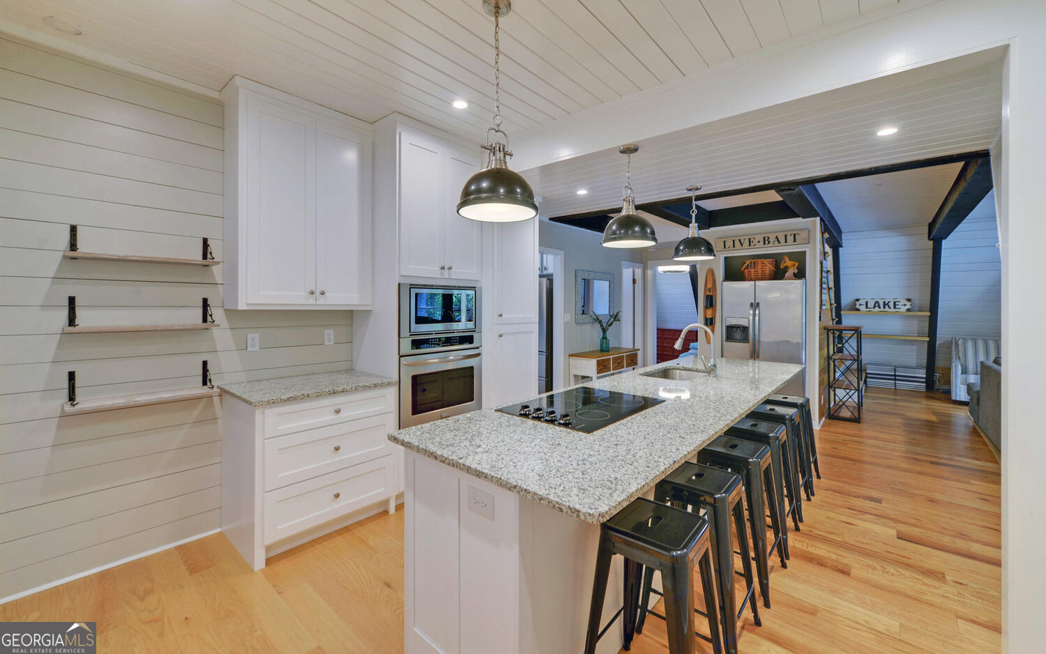 1047 Tranquility Lane Hartwell, GA 30643 - Photo 9 of 60 a kitchen with granite countertop a table chairs stainless steel appliances and wooden floor