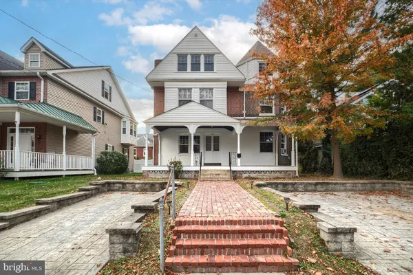 a front view of a house with a yard patio and fire pit