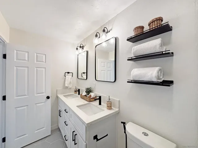 a bathroom with a sink mirror and vanity
