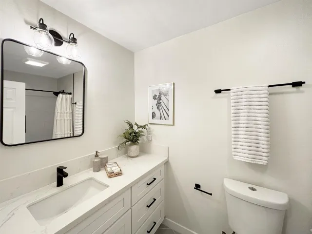 a bathroom with 2 sink and a mirror