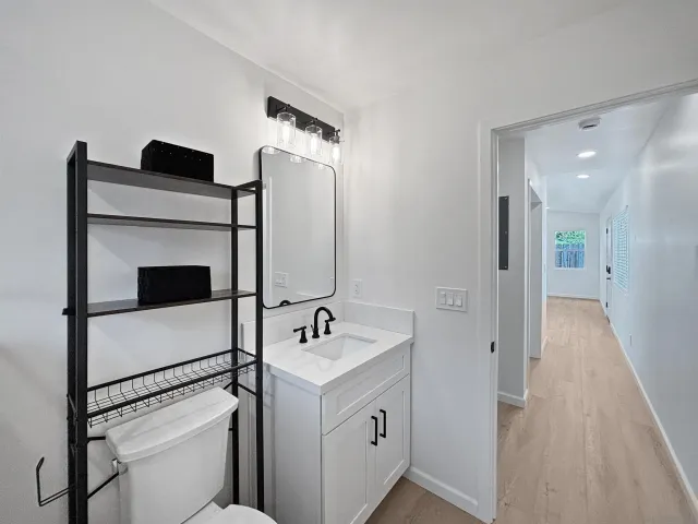 a bathroom with a sink toilet and shower